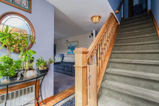 a bedroom with a bed and a mirror on the dresser
