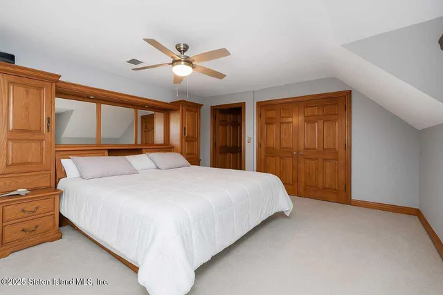 a bedroom with two beds and a window