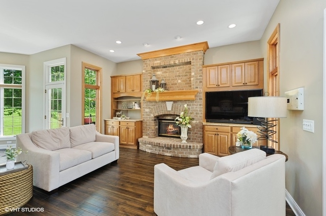7313 Lone Oak Road Spring Grove, IL 60081 - Photo 11 of 29 a living room with furniture fireplace and flat screen tv