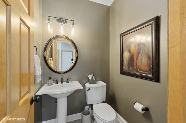 7313 Lone Oak Road Spring Grove, IL 60081 - Photo 12 of 29 a bathroom with a toilet sink and mirror