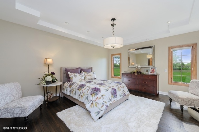 7313 Lone Oak Road Spring Grove, IL 60081 - Photo 15 of 29 a bedroom with a bed and wooden floor