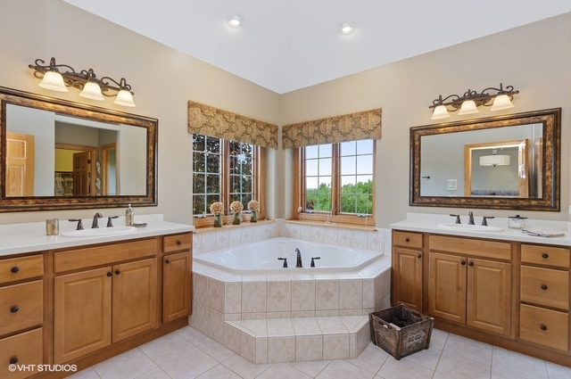 7313 Lone Oak Road Spring Grove, IL 60081 - Photo 16 of 29 a spacious bathroom with a tub sink and mirror