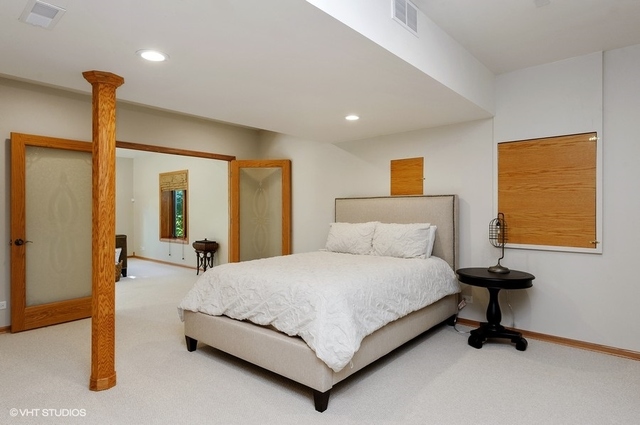 7313 Lone Oak Road Spring Grove, IL 60081 - Photo 22 of 29 a bedroom with a bed and wall painting