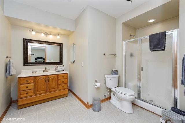 7313 Lone Oak Road Spring Grove, IL 60081 - Photo 23 of 29 a bathroom with a toilet a sink and mirror