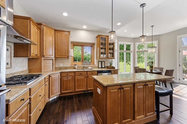 7313 Lone Oak Road Spring Grove, IL 60081 - Photo 8 of 29 a kitchen with stainless steel appliances granite countertop a stove a sink dishwasher and a refrigerator with wooden floor