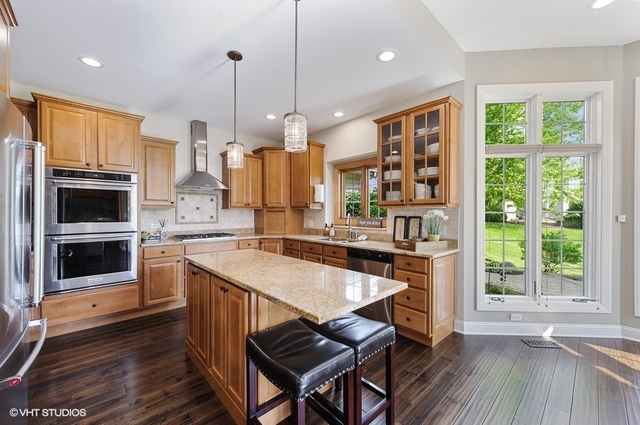 7313 Lone Oak Road Spring Grove, IL 60081 - Photo 9 of 29 a kitchen with a table chairs sink and refrigerator
