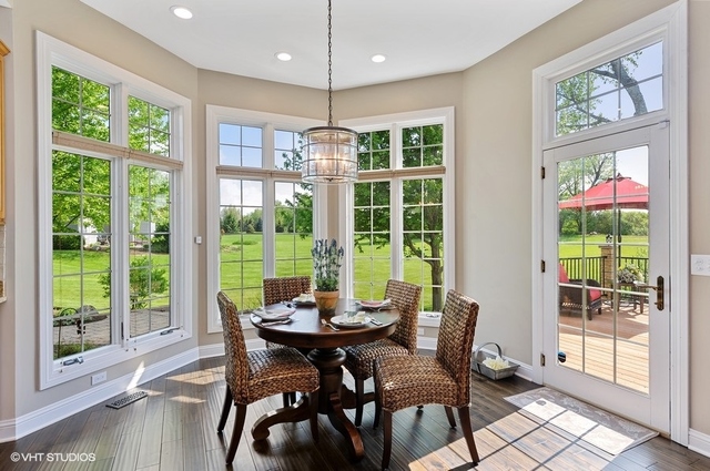 7313 Lone Oak Road Spring Grove, IL 60081 - Photo 10 of 29 a view of a dining room with furniture large windows and wooden floor