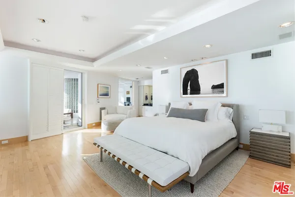 a bedroom with a large bed and a fireplace