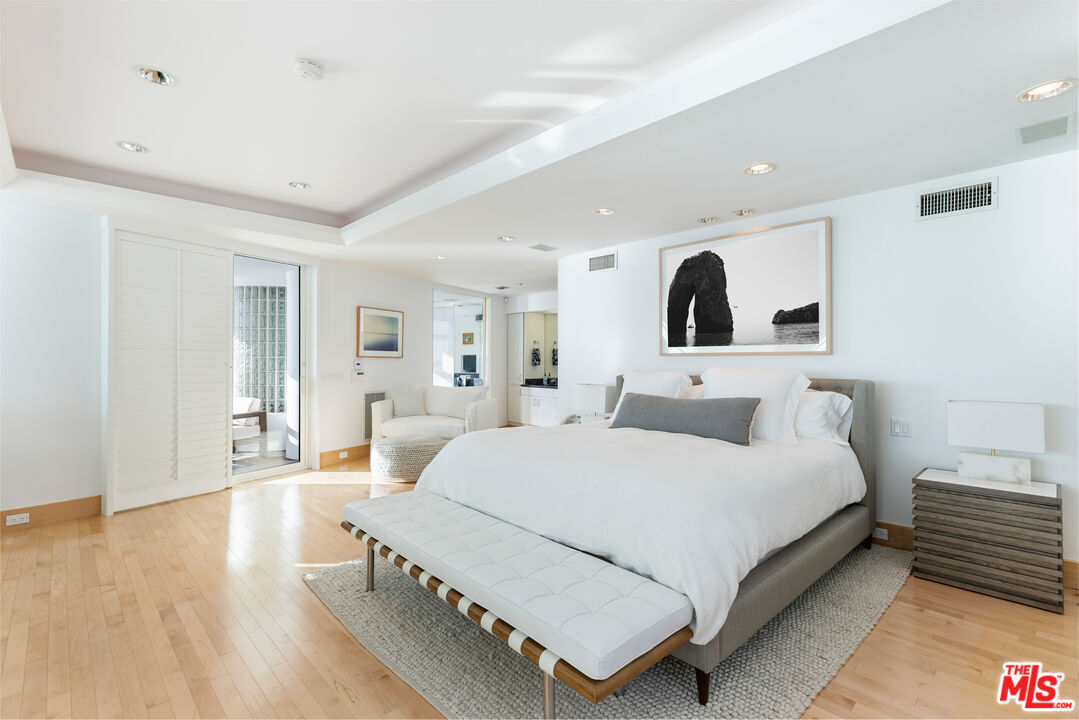 32062 Pacific Coast Highway Malibu, CA 90265 - Photo 11 of 31 a bedroom with a large bed and a wooden floor