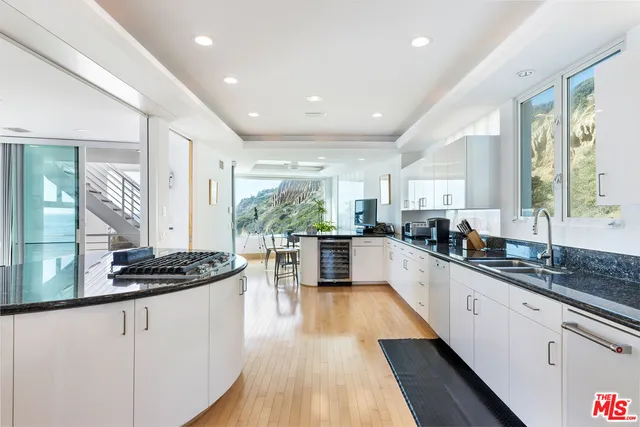 a dining room with furniture and a potted plant