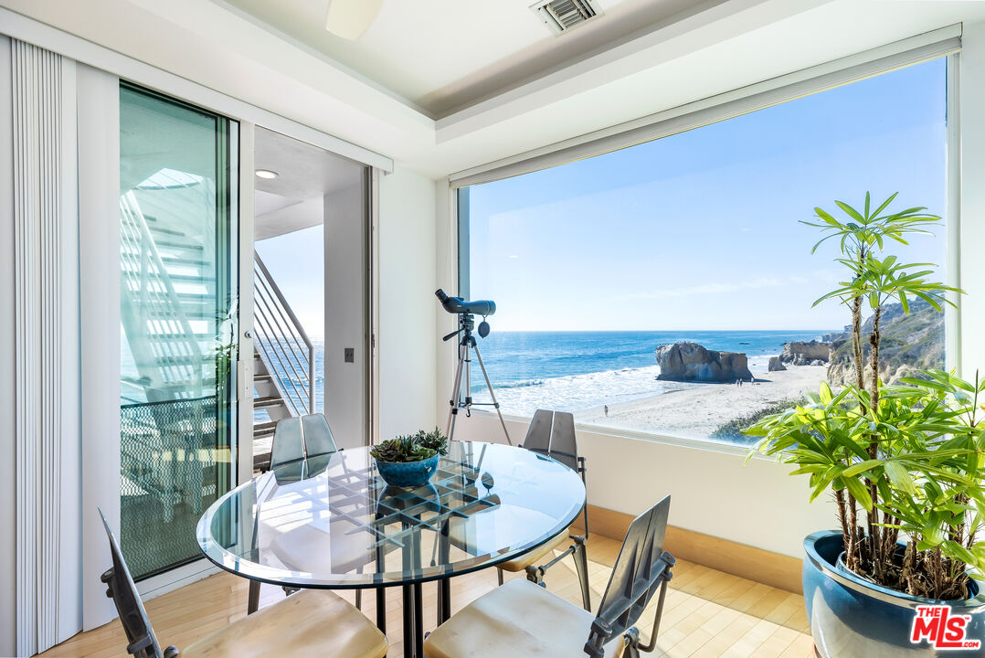 32062 Pacific Coast Highway Malibu, CA 90265 - Photo 16 of 31 a dining room with furniture and a potted plant