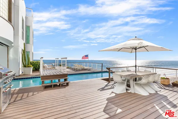 a roof deck with patio and furniture