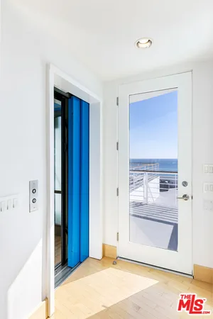 a view of a terrace with wooden floor and ocean view