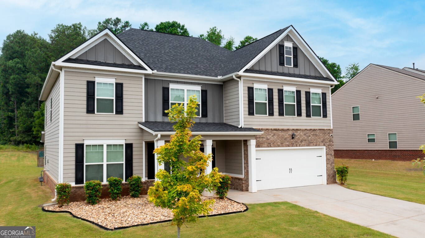 8084 Louis Drive Locust Grove, GA 30248 - Photo 1 of 33 a front view of a house with garden