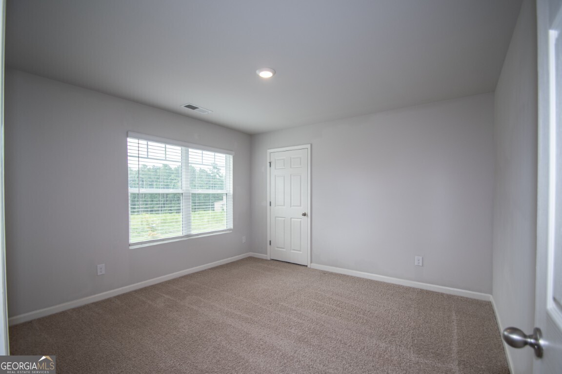 8084 Louis Drive Locust Grove, GA 30248 - Photo 17 of 33 an empty room with a window
