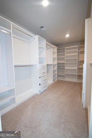 a view of a kitchen with a sink and a refrigerator