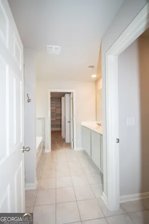 a large bathroom with a sink and a mirror