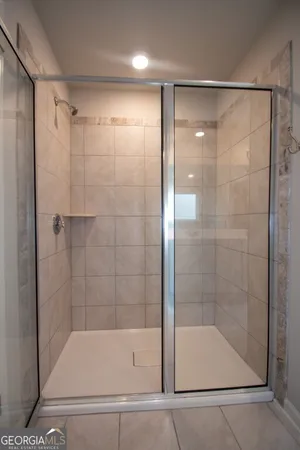 a bathroom with a sink a mirror and a shower