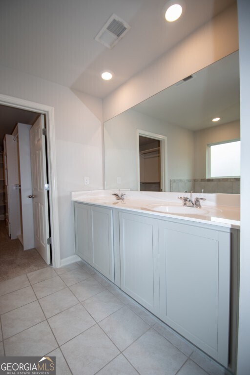 8084 Louis Drive Locust Grove, GA 30248 - Photo 29 of 33 a bathroom with a sink a mirror and a shower