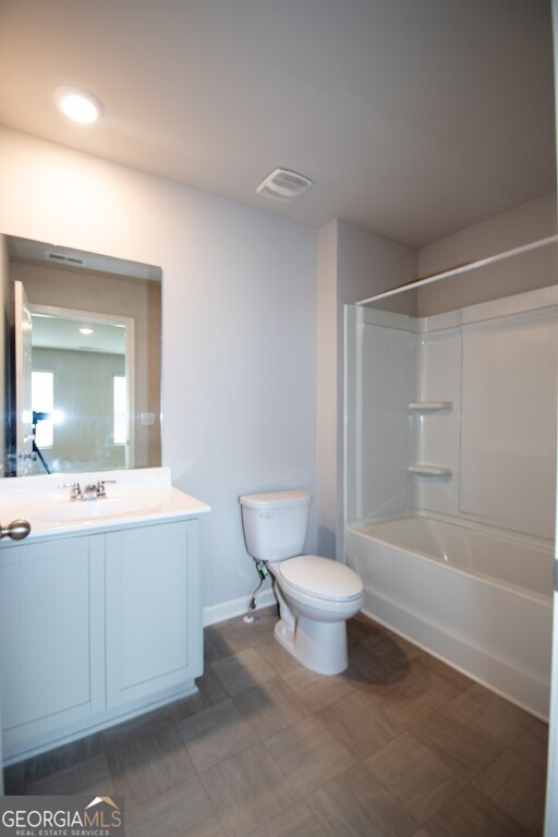 8084 Louis Drive Locust Grove, GA 30248 - Photo 32 of 33 a bathroom with a toilet sink and mirror