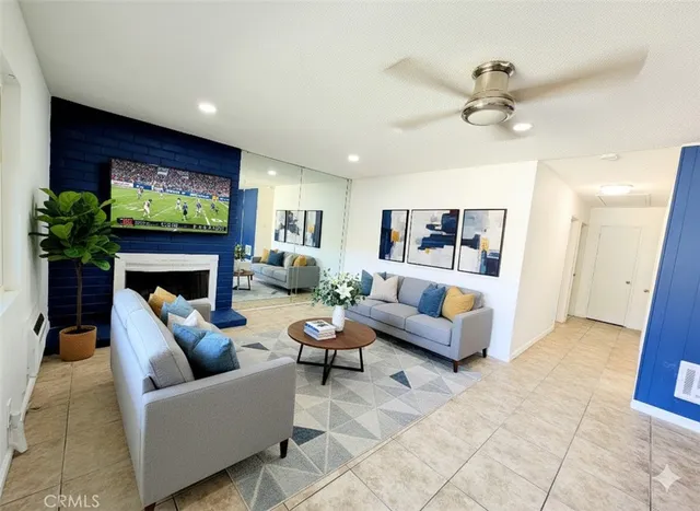 a living room with furniture a fireplace and a flat screen tv