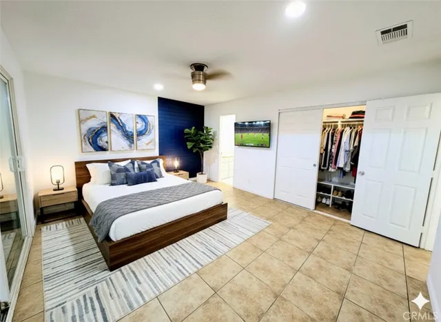 a spacious bedroom with a bed and a walk in closet