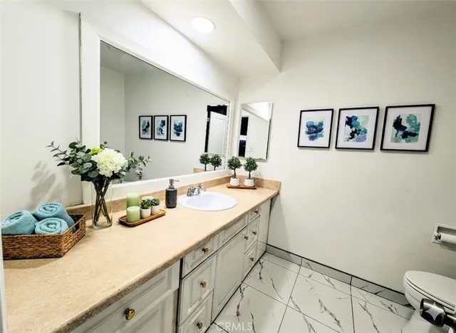 a bathroom with a sink mirror and vanity
