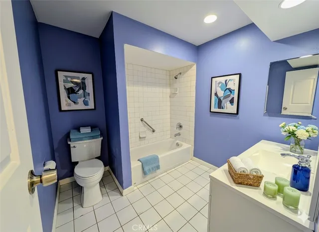 a bathroom with a granite countertop sink a toilet and bathtub