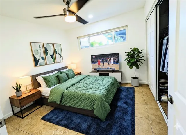 a bed sitting in a bedroom next to a window