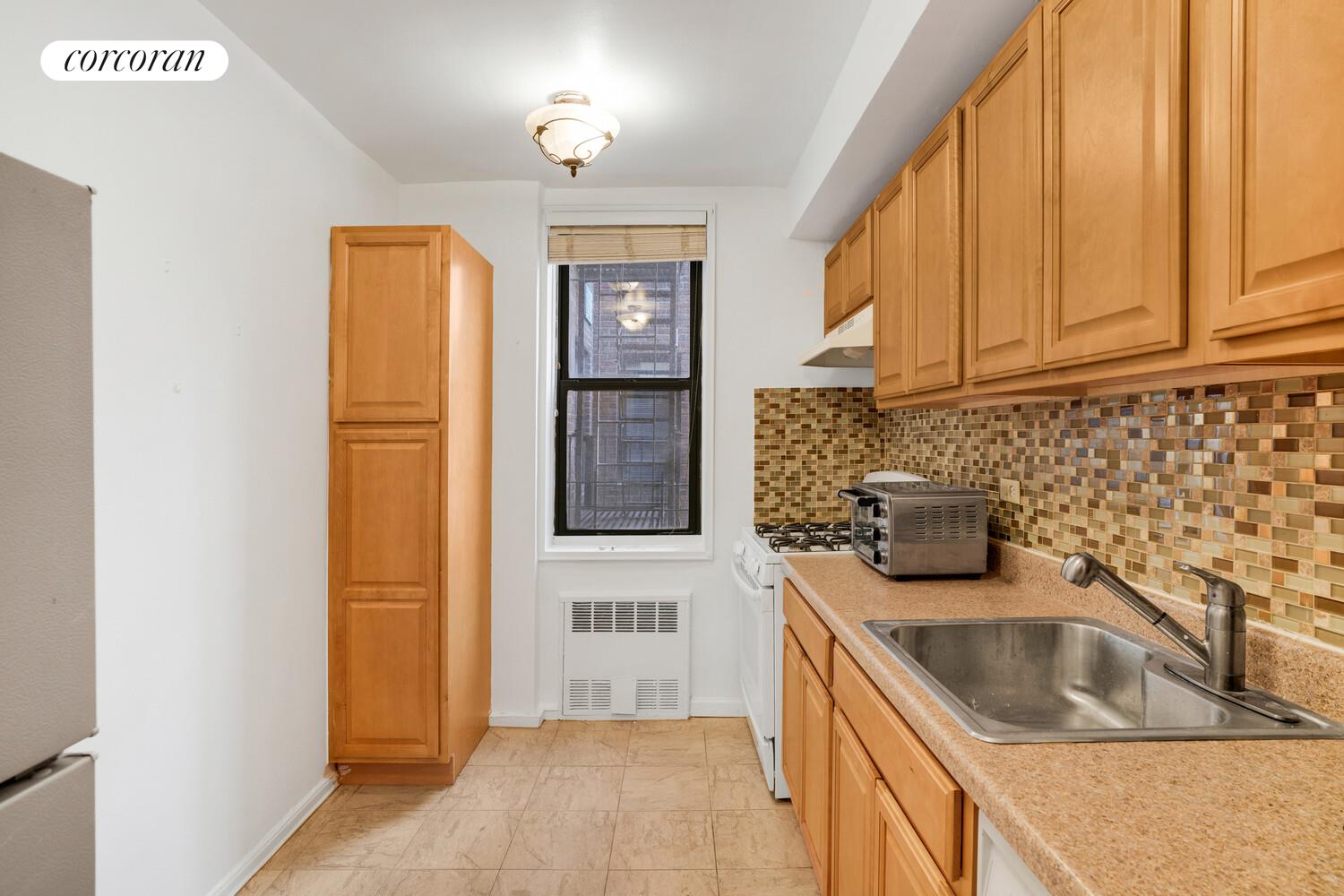 345 Webster Avenue, Unit 1G Brooklyn, NY 11230 - Photo 6 of 12 a kitchen with a sink a stove and cabinets