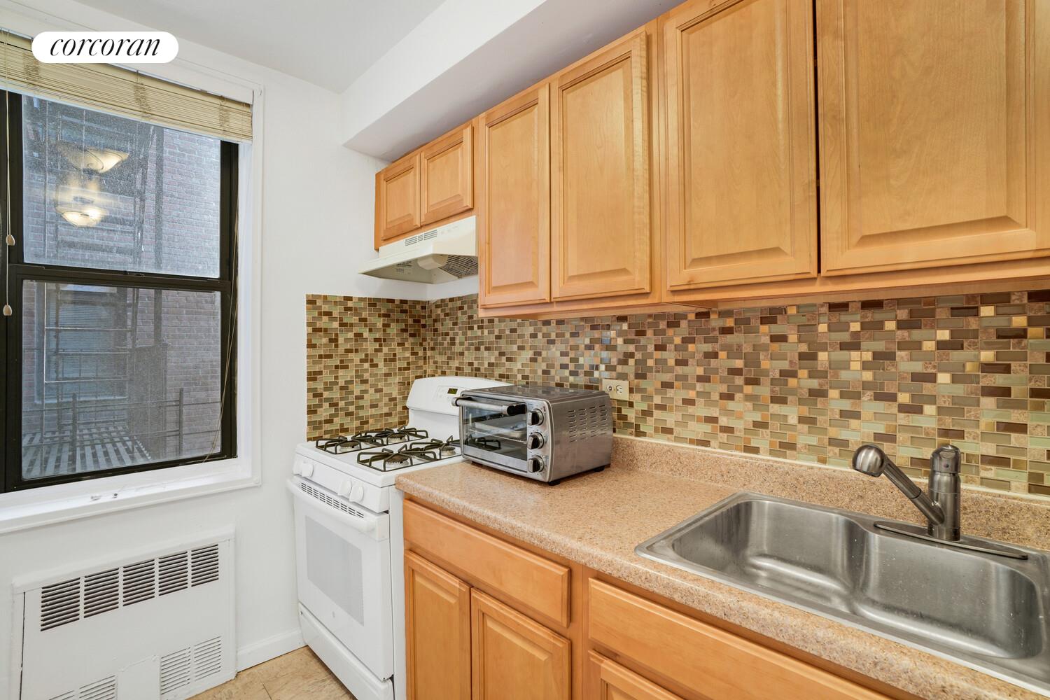 345 Webster Avenue, Unit 1G Brooklyn, NY 11230 - Photo 8 of 12 a kitchen with a sink and cabinets