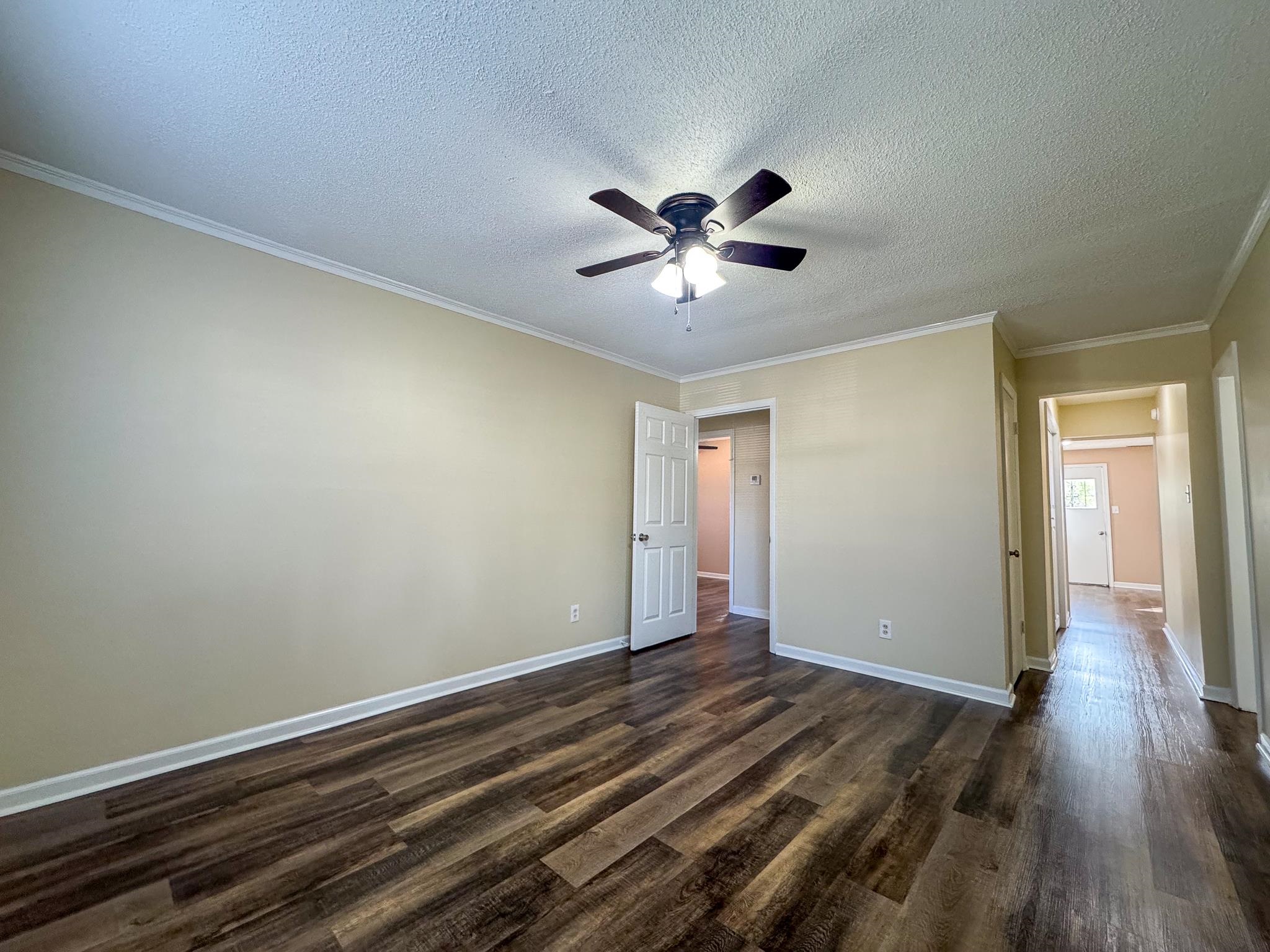 842 Rock Road Memphis, TN 38122 - Photo 11 of 26 Unfurnished bedroom with ornamental molding, baseboards, and dark wood-style flooring