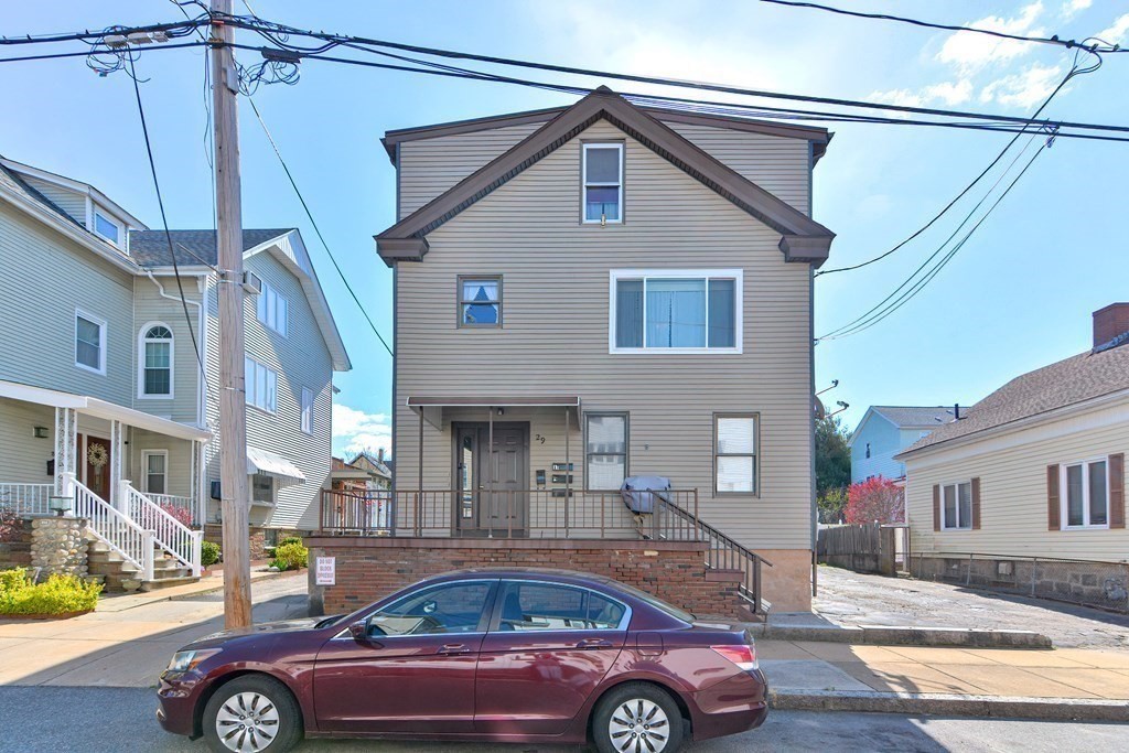 a front view of a house with parking space