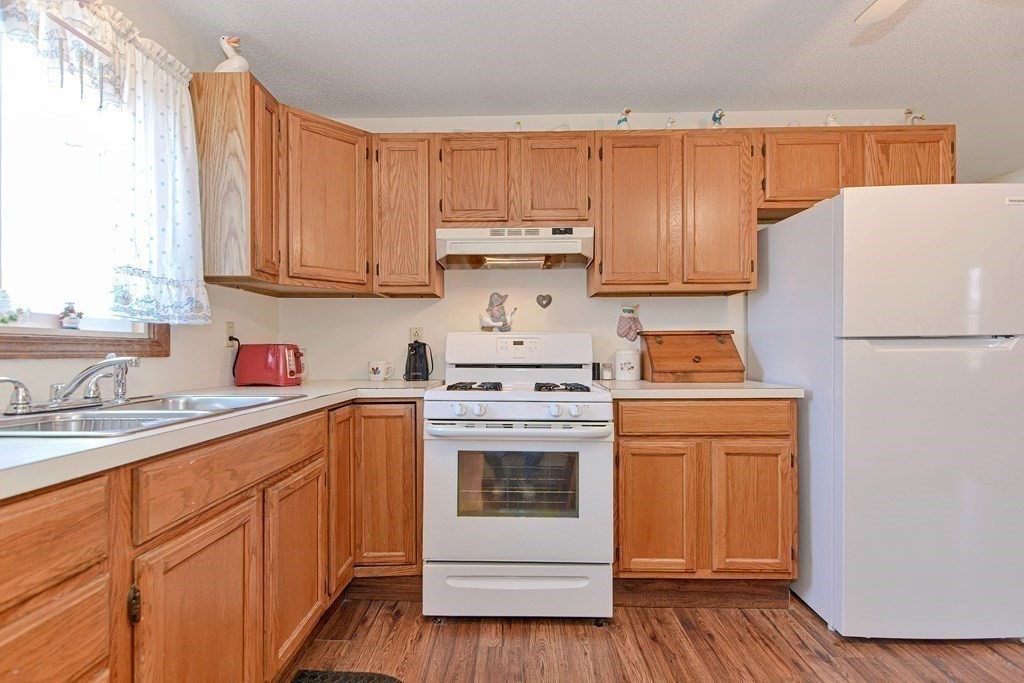 29 Winter Street Fall River, MA 02720 - Photo 12 of 34 a kitchen with a white cabinets and white appliances