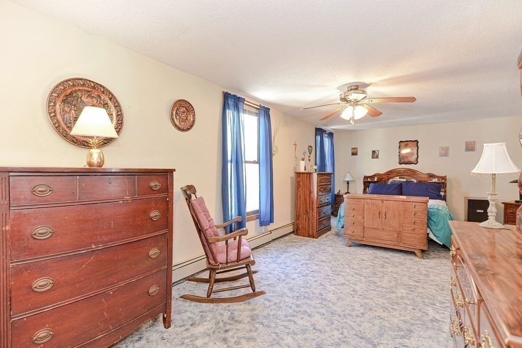 29 Winter Street Fall River, MA 02720 - Photo 15 of 34 a bedroom with a bed and a chandelier