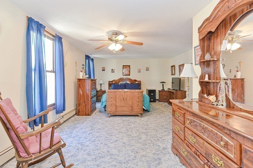 29 Winter Street Fall River, MA 02720 - Photo 16 of 34 a bedroom with furniture and a chandelier