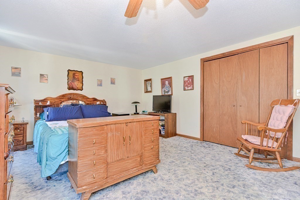 29 Winter Street Fall River, MA 02720 - Photo 17 of 34 a bedroom with a bed and a chair