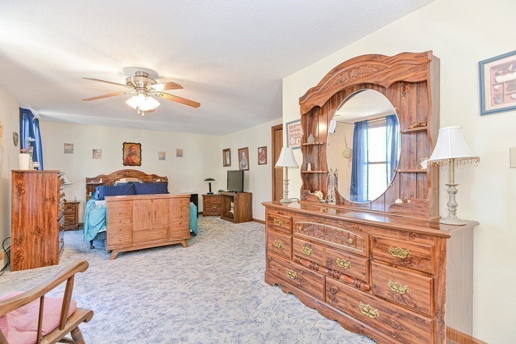 29 Winter Street Fall River, MA 02720 - Photo 18 of 34 a living room with furniture a fireplace and a chandelier