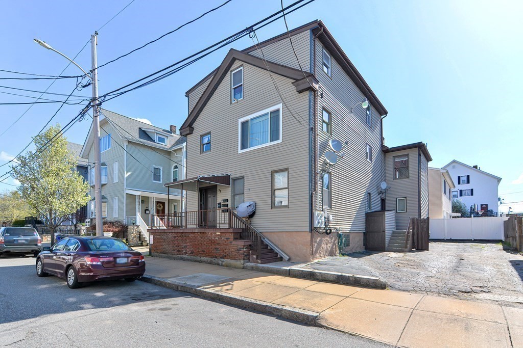 29 Winter Street Fall River, MA 02720 - Photo 2 of 34 a car parked in front of a white house