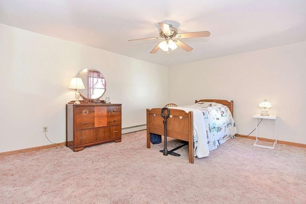 29 Winter Street Fall River, MA 02720 - Photo 21 of 34 a bed sitting in a room with furniture