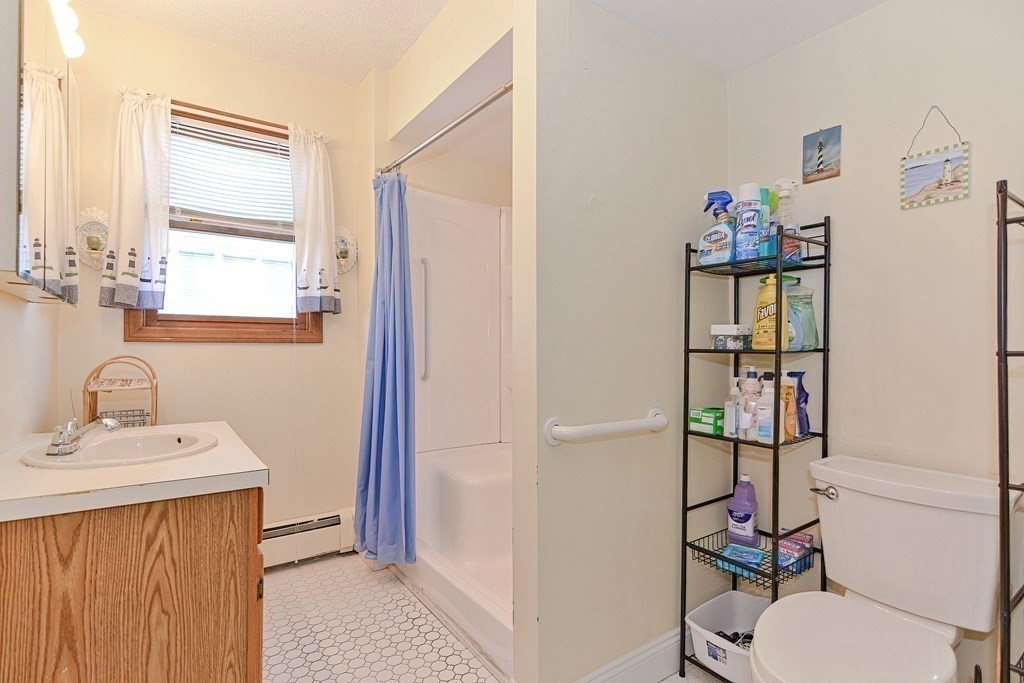 29 Winter Street Fall River, MA 02720 - Photo 25 of 34 a bathroom with a toilet a sink and a mirror