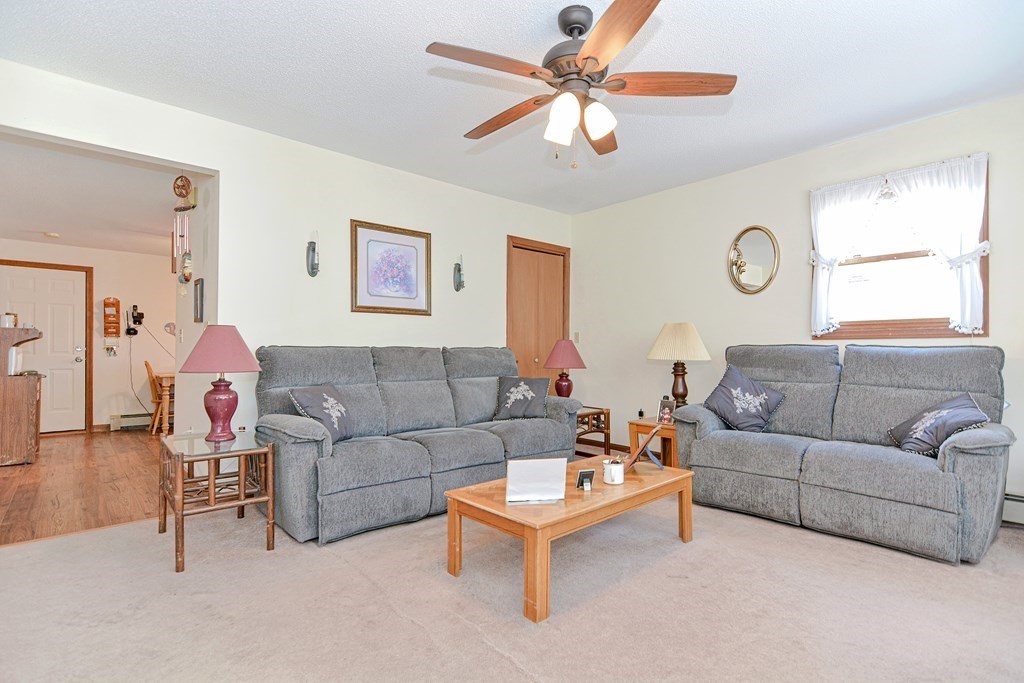 29 Winter Street Fall River, MA 02720 - Photo 5 of 34 a living room with furniture a large window and a clock