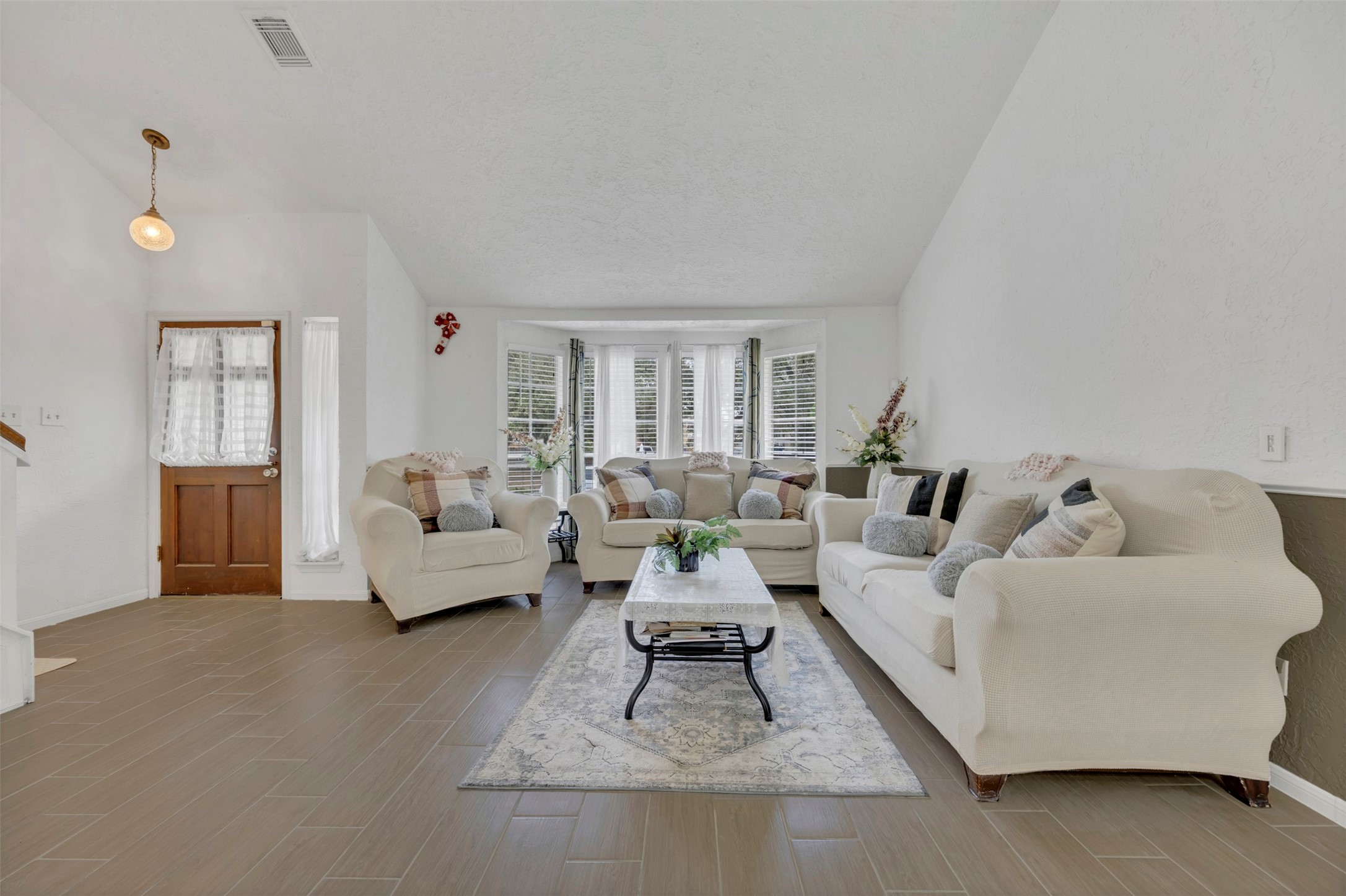 15619 Beechnut Street Houston, TX 77083 - Photo 5 of 29 Spacious and bright living area featuring large bay windows — perfect for morning coffee or evening gatherings.