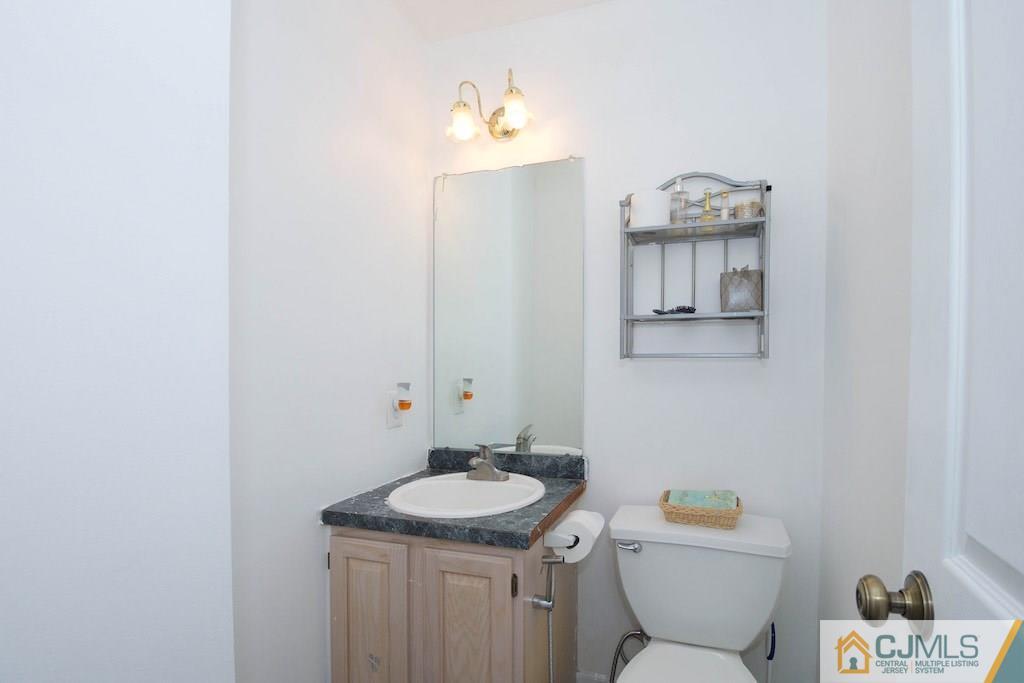 98 New Brooklyn Road Edison, NJ 08817 - Photo 11 of 21 a bathroom with a granite countertop sink a toilet and a mirror