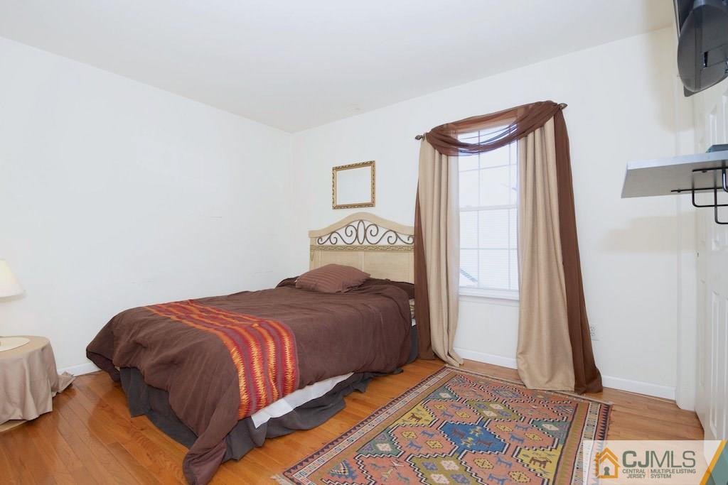 98 New Brooklyn Road Edison, NJ 08817 - Photo 16 of 21 a bedroom with a bed and a night stand