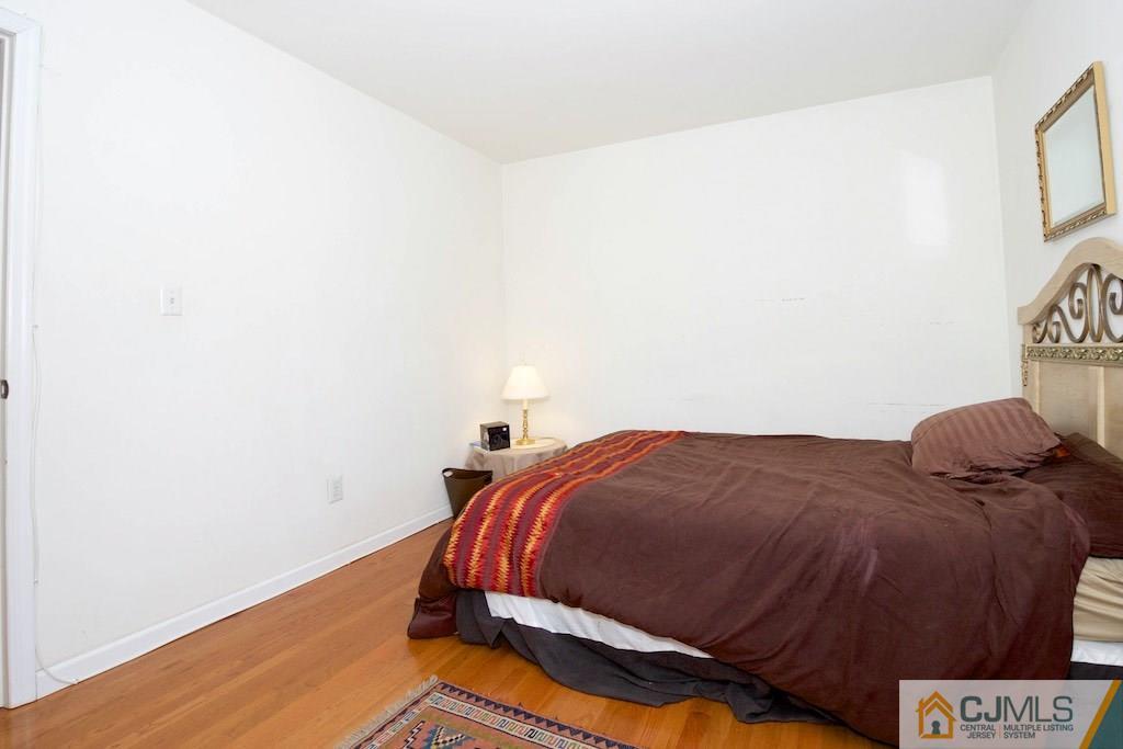 98 New Brooklyn Road Edison, NJ 08817 - Photo 17 of 21 a bedroom with a bed and cupboard