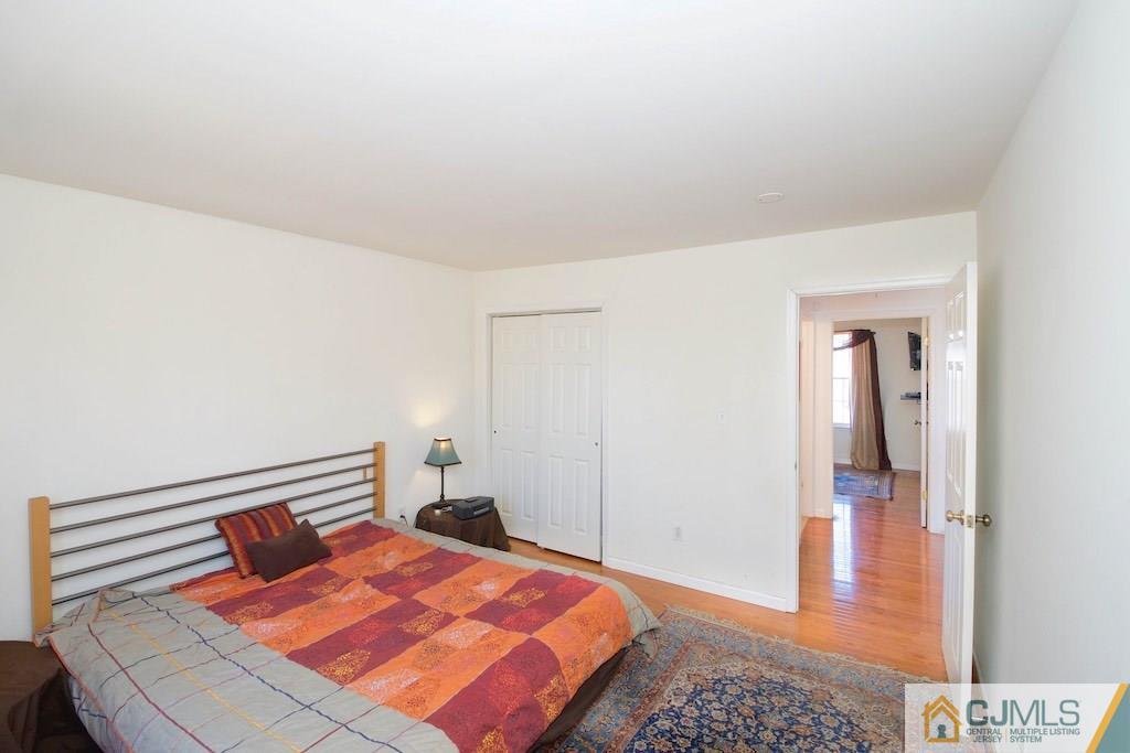 98 New Brooklyn Road Edison, NJ 08817 - Photo 18 of 21 a bedroom with a bed and wooden floor
