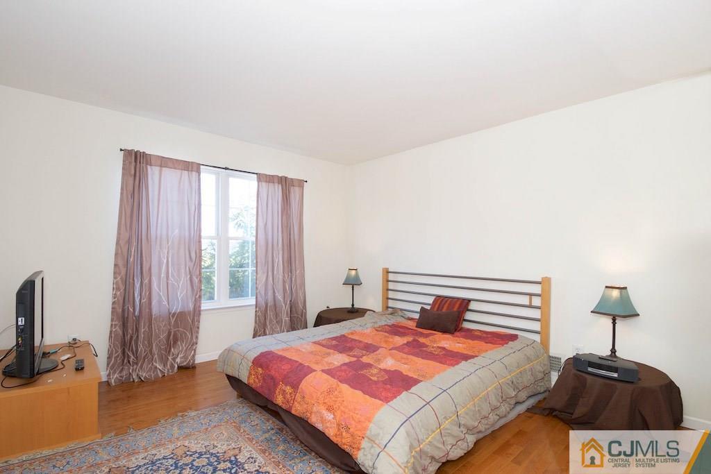 98 New Brooklyn Road Edison, NJ 08817 - Photo 19 of 21 a bedroom with a bed and a window