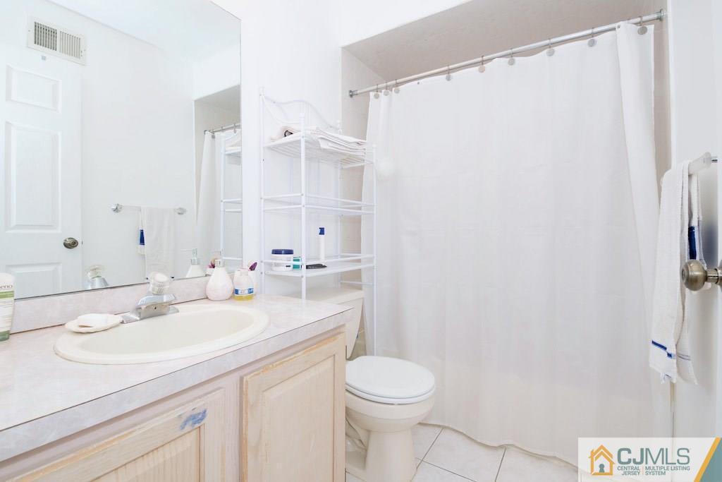 98 New Brooklyn Road Edison, NJ 08817 - Photo 20 of 21 a bathroom with a sink a toilet and a mirror