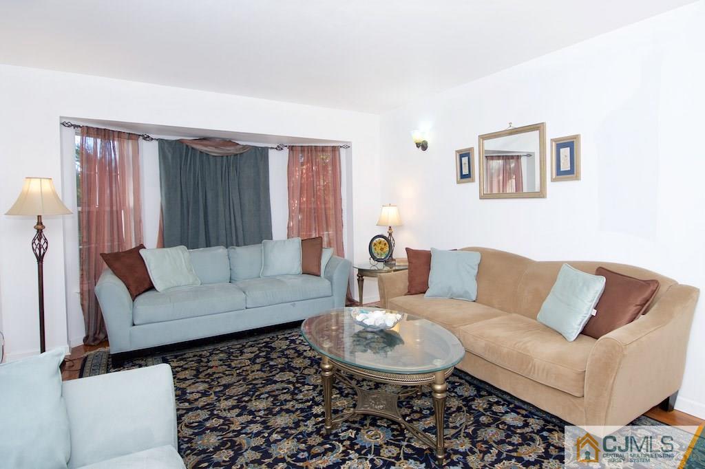 98 New Brooklyn Road Edison, NJ 08817 - Photo 4 of 21 a living room with furniture and a couch